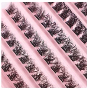 Macro shot of dense black segment eyelash clusters with DD curl on pink plastic tray