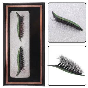 Dramatic false eyelashes with sparkling green glitter eyeliner on a black display card