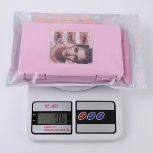 Lash extension kit weighing 96g with pink tweezers, bond, seal, and storage box