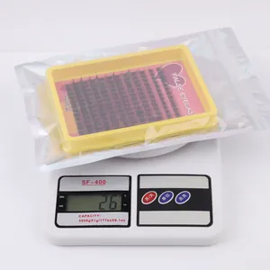DIY individual eyelash extensions kit showing 26g total weight on a scale