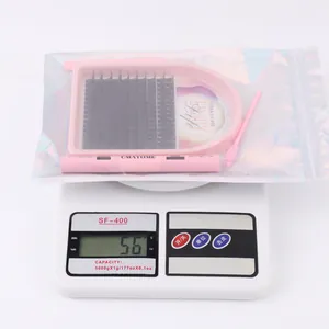 DIY eyelash extension kit in holographic bag weighing 56g on a digital scale