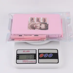 Pink DIY lash extension kit with cluster lashes, glue, tweezers and brush on scale