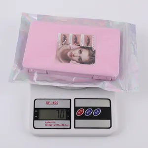 Detailed view of individual lash cluster box weighing 70g on a digital electronic scale