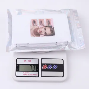 Cluster lash extensions kit in iridescent zip bag showing 73g weight on digital scale
