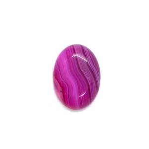 Macro detail of oval cabochon agate stone with pink and white striped patterns