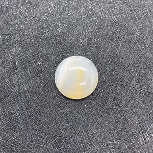 Detailed macro view of a round polished natural striped agate cabochon stone
