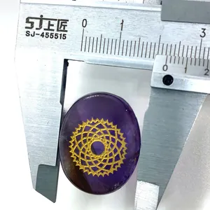 Detail showing measurement of oval purple amethyst stone with gold geometric pattern
