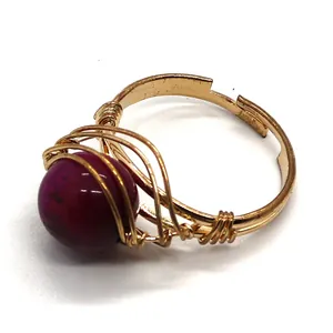 Handmade gold wire-wrapped ring featuring a round natural amethyst stone and adjustable band