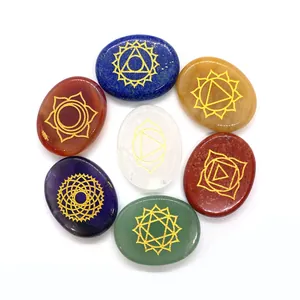 Polished 7 Chakra healing stones set with gold engraved chakra symbols on oval crystals