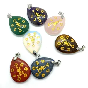 Set of 7 teardrop chakra stones with gold yoga engravings and natural gemstone textures