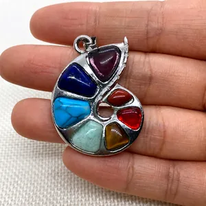Handheld view of a zinc alloy snail-shaped pendant featuring seven colorful natural stones