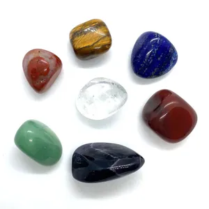 Set of 7 natural semi-precious stones including tiger eye and lapis lazuli in irregular shapes