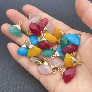 Macro shot of colorful faceted gemstone pendants held in hand for DIY jewelry making