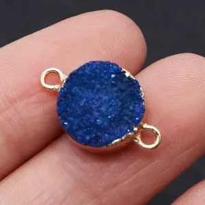Detailed macro view of a blue druzy agate stone connector with gold plated edges and loops