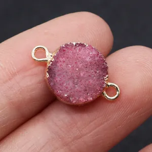 Macro view of pink druzy crystal connector with gold plated rim for DIY jewelry