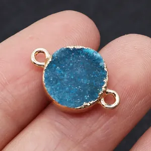Macro detail of blue druzy crystal connector with gold bezel and dual rings for DIY jewelry
