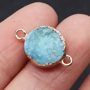 Macro view of a round blue druzy crystal connector with gold plated edges for DIY jewelry