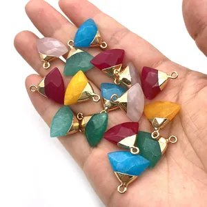 Handheld view of assorted faceted triangle gemstone pendants with gold plated edges