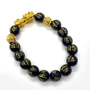 Pulsera de cuentas de obsidiana con dije Pi Xiu dorado y símbolos de mantra grabados