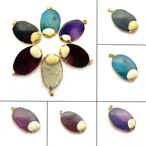 Macro detail of various natural agate oval pendants with gold plating and shell inlay