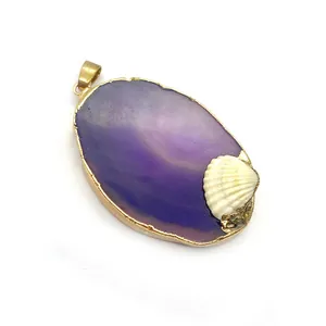 Detailed macro view of purple agate oval pendant with gold plating and small white shell