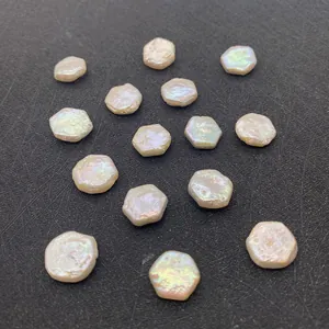 Gros plan de perles d'eau douce baroques hexagonales montrant un lustre naturel sur fond noir