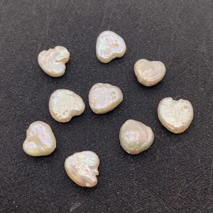 Macro shot of 9 natural freshwater heart-shaped baroque pearls with iridescent luster