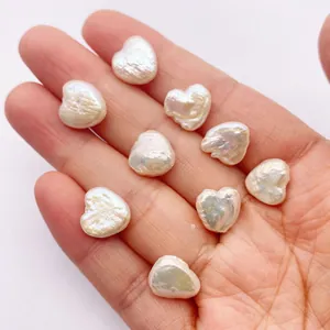 Natural heart-shaped baroque freshwater pearl beads held in hand for jewelry making