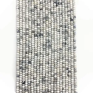 Macro view of faceted natural stone beads with black and white marble textures for DIY crafts