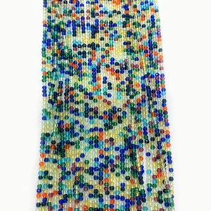 Macro view of colorful faceted glass beads in a vibrant rainbow spectrum for DIY jewelry
