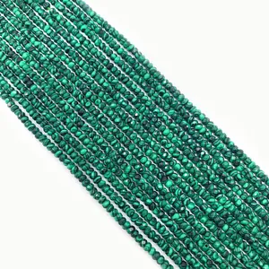 Macro view of faceted natural malachite beads showing green stripes for DIY jewelry