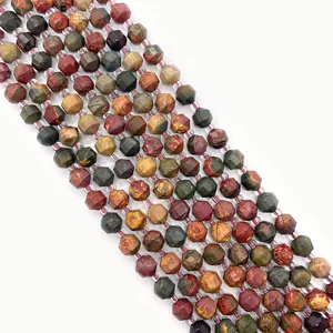 Macro shot of faceted Dragon Blood stone beads with natural green and red mineral textures