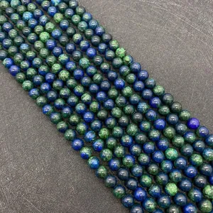 Macro view of round Phoenix Lapis Lazuli beads showing natural blue and green patterns