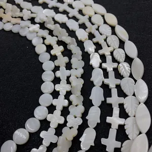 Natural white shell beads set with hamsa, cross and leaf shapes for DIY jewelry making