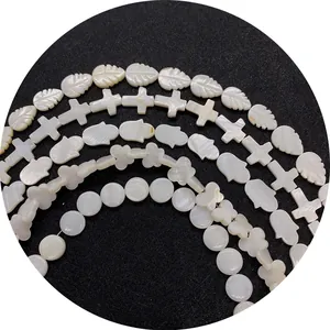 Natural white mother of pearl shell beads set in leaf, cross, hamsa and flower shapes
