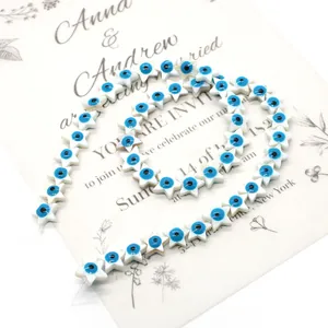 Macro detail of star-shaped natural mother of pearl beads with blue evil eye pattern