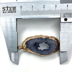Detail view of irregular purple agate crystal pendant with gold edge measuring 3.8cm