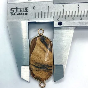 Macro view of oval dalmatian jasper stone pendant measured with a caliper