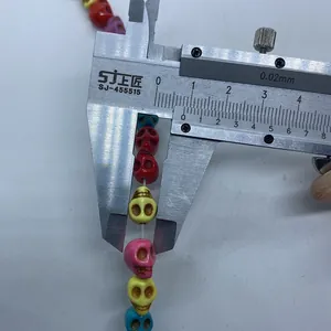 Caliper measuring 10mm colorful skull-shaped turquoise stone beads for DIY jewelry