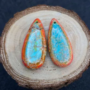 Primer plano de colgantes de jaspe imperial en forma de gota con textura azul y naranja