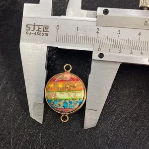 Detailed macro view of a 20mm round rainbow stone pendant with gold plating