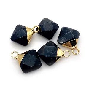 Macro detail of four faceted black onyx diamond pendants with gold plated bail connectors