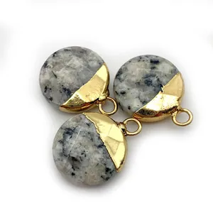 Detailed view of three circular natural stones with black spots and gold-plated edges