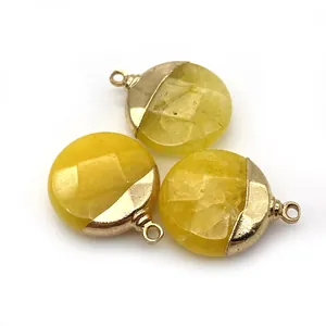 Close-up of three faceted yellow natural stone pendants with gold metal caps for DIY jewelry