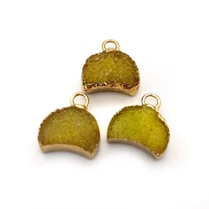 Trois pendentifs demi-lune en pierre naturelle avec bordure dorée et cristaux verts vifs