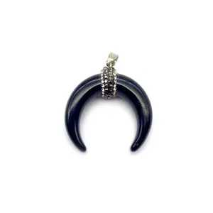 Detailed view of polished black resin crescent moon pendant with micro pavé crystals