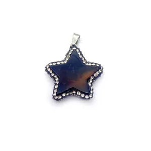 Macro shot of star-shaped natural stone pendant with sparkling rhinestone pavé edges
