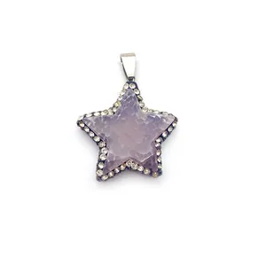 Macro detail of star-shaped purple crystal pendant with sparkling diamond-encrusted edges
