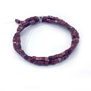 Makroaufnahme von quadratischen Würfelperlen aus rotem Kaiserstein für DIY Schmuck