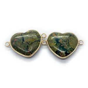 Close-up of heart-shaped natural stone connectors with gold plated edges for DIY jewelry
